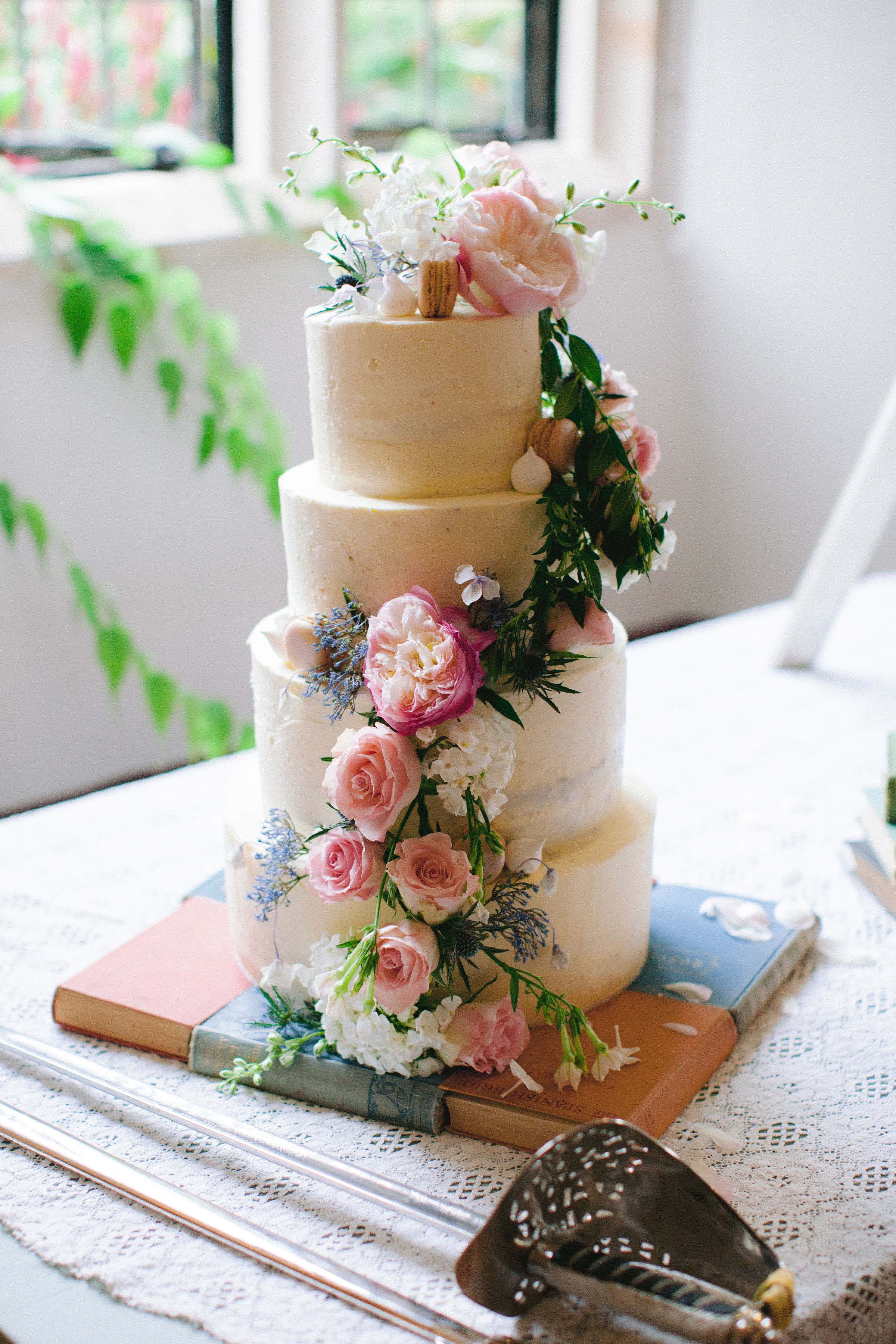 Quintessential English Summer wedding cake decorated with fresh garden flowers. Photo by Camila Arnhold.