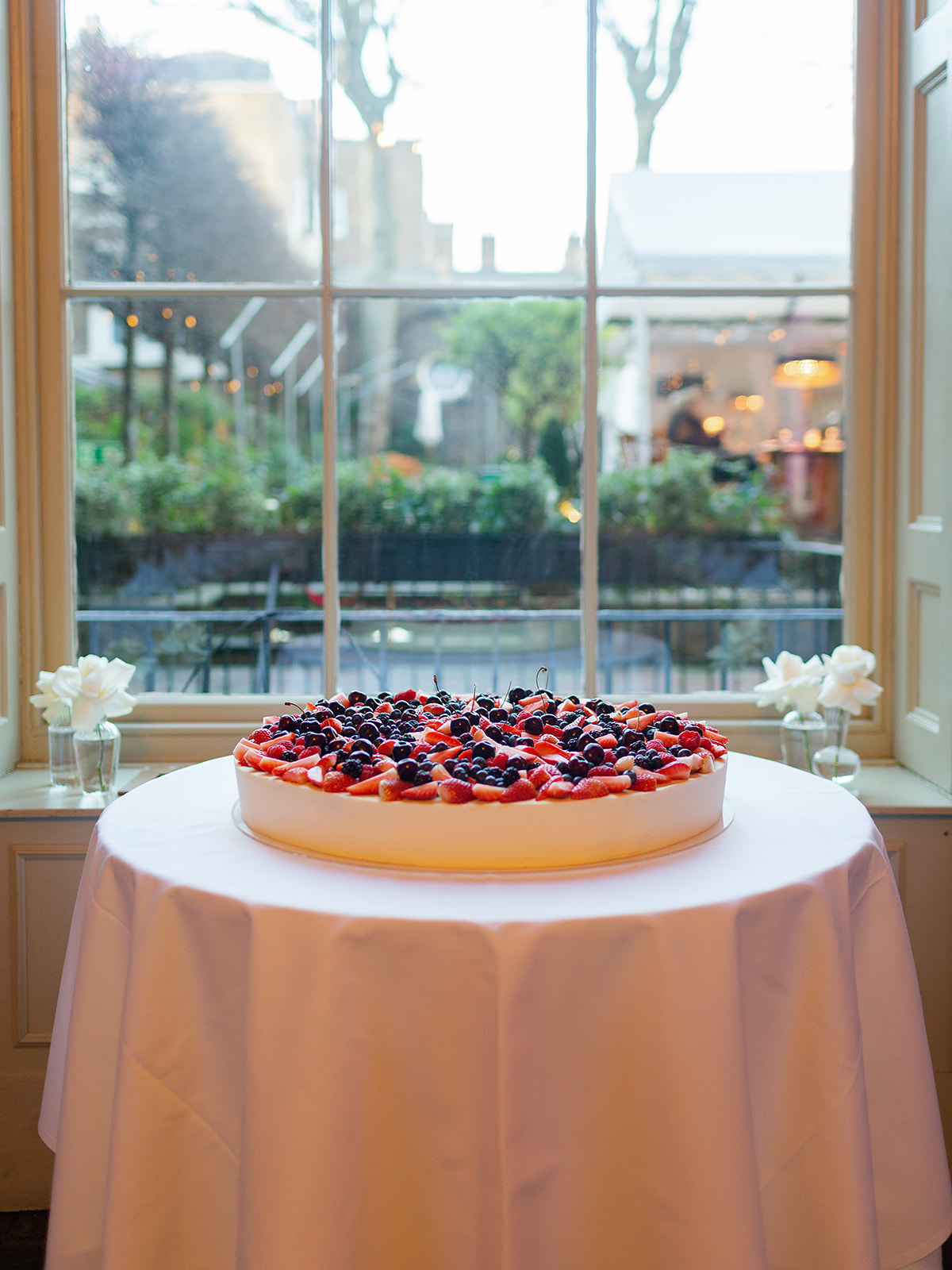 Large Single Tier sponge wedding cake decorated with fresh berries and fruit | Home House London