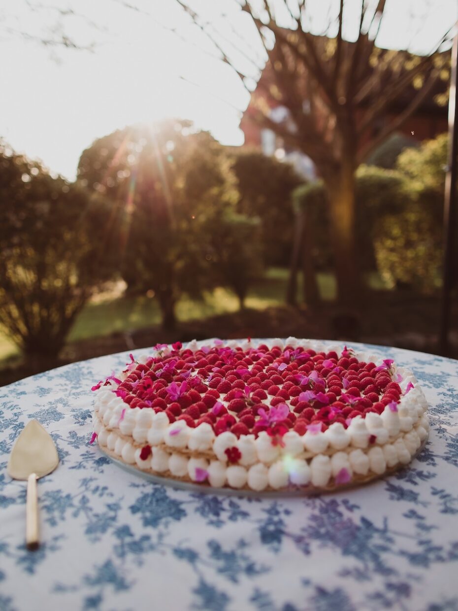Medium sized Millefoglie Italian wedding cake decorated with fresh raspberries and edible flowers | The Springles