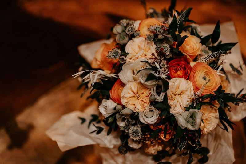 Bridal bouquet in orange. peach and ivory flowers | Johanna Pedrick Flowers | Bingham Riverhouse Richmond upon Thames UK | The Unscripted