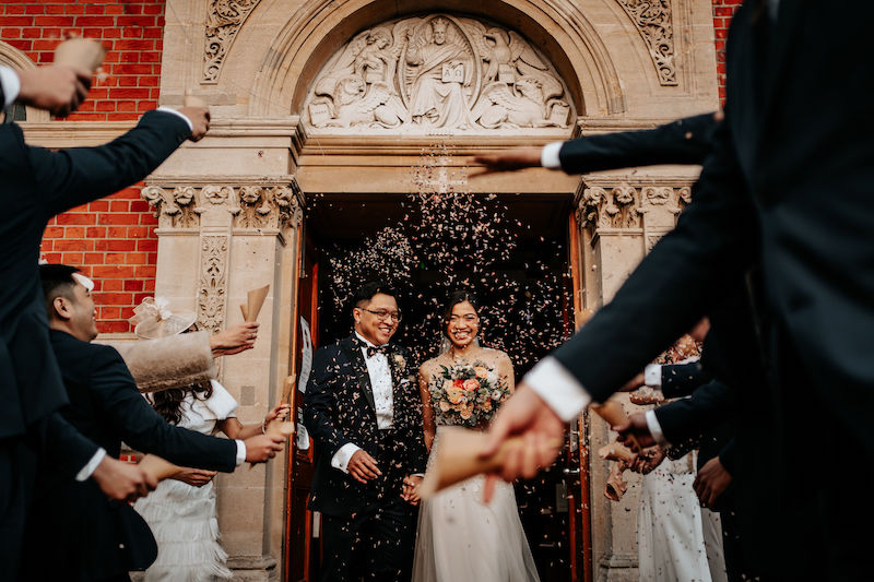 Confetti at small Catholic wedding ceremony at St Agathas Church Kingston upon Thames | Asian bridal couple | The Unscripted