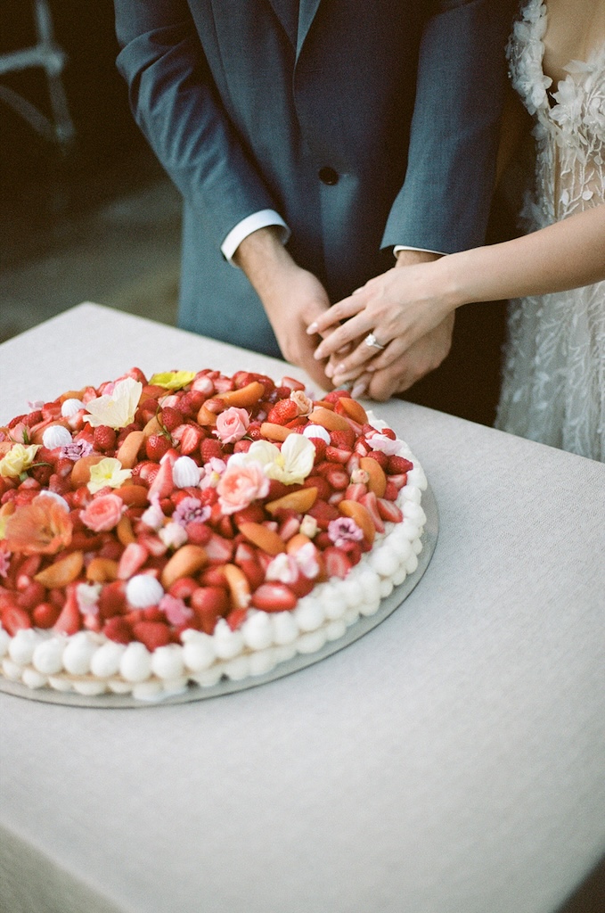 Millefoglie wedding cake decorated with fresh strawberries, raspberries, blueberries and apricots with pastel-coloured edible flowers at Euridge Manor | The Cotswolds