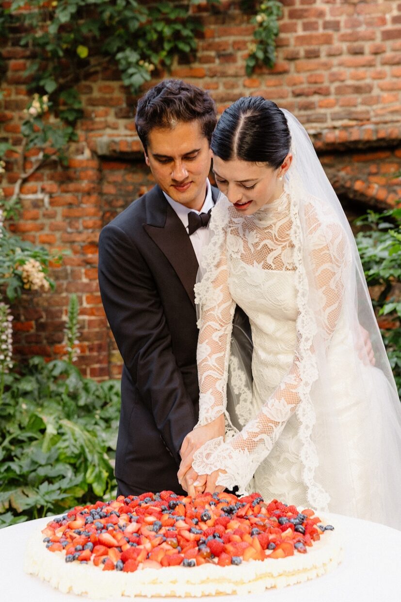 Couple cutting millefoglie italian wedding cake at fusion wedding at The Charterhouse | Clerkenwell London | Ela Tatiana Photography